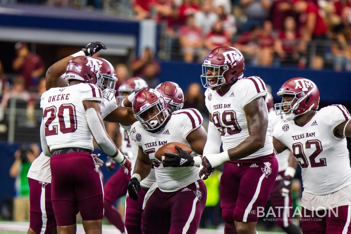 Junior defensive lineman Justin Madubuike celebrates his interception with the Aggie defense.