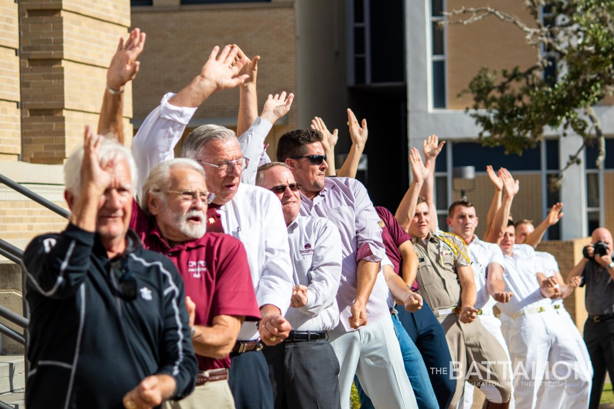 Current and former Yell Leaders hold Yell Practice on the steps of Cushing to celebrate new exhibit. 