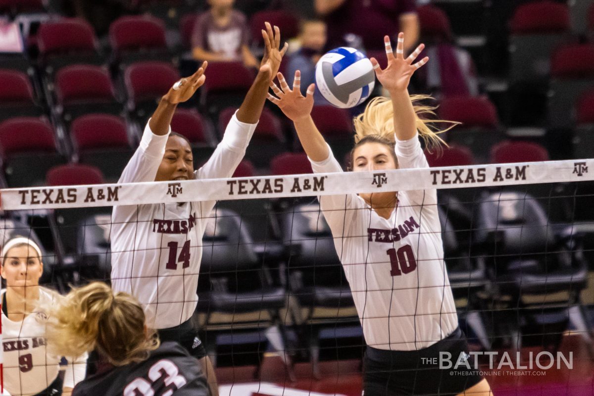 Junior&#160;Makenna Patterson&#160;and freshman&#160;Treyaunna Rush block a pass over the net.