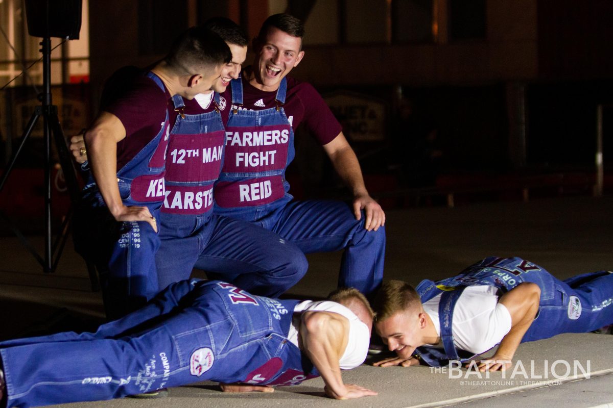 The senior yell leaders wait while the junior yell leaders complete their push ups before Yell Practice.