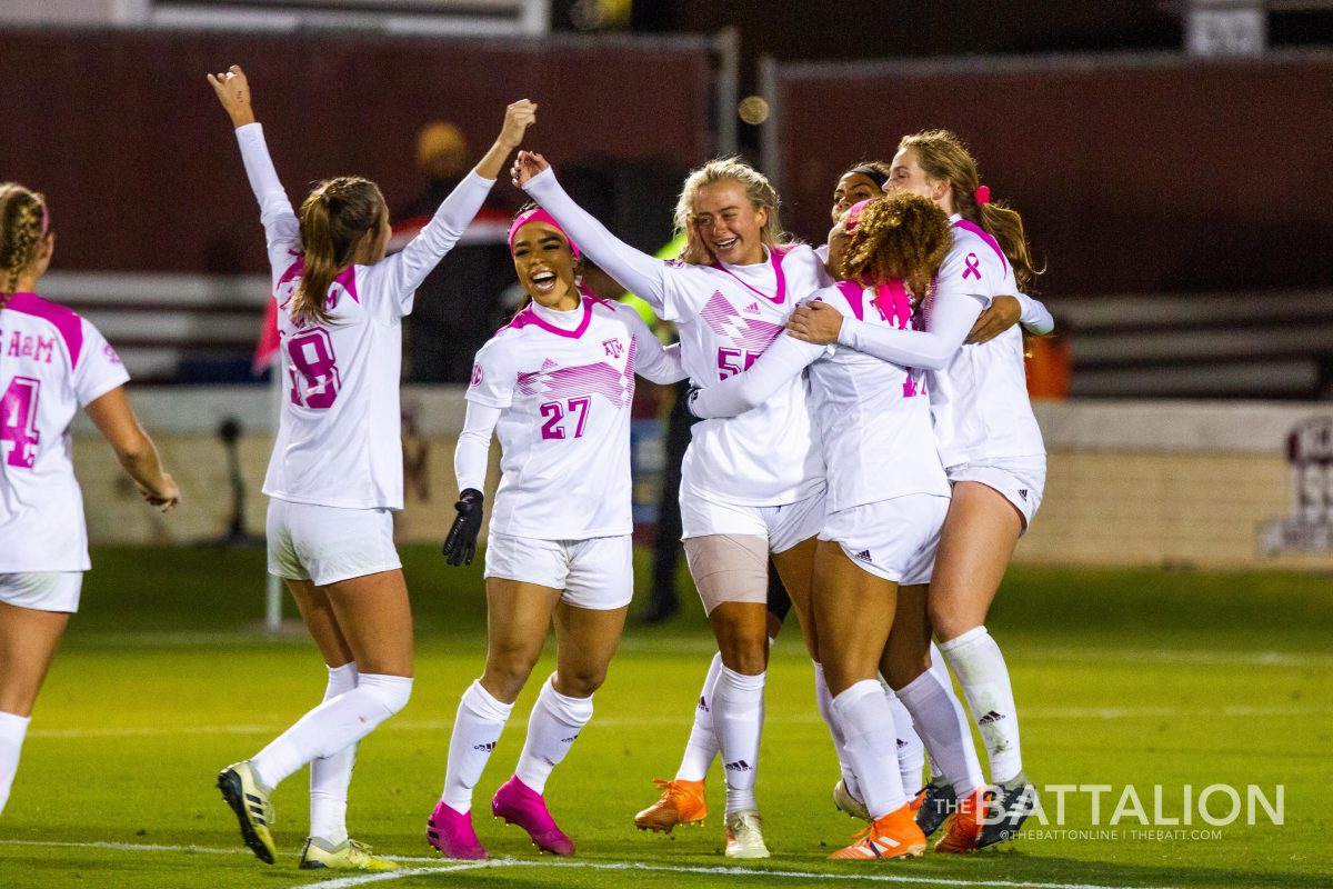 Sophomore forward Abby Grace Cooper celebrates with teammates after scoring the go-ahead-goal for the Aggies.