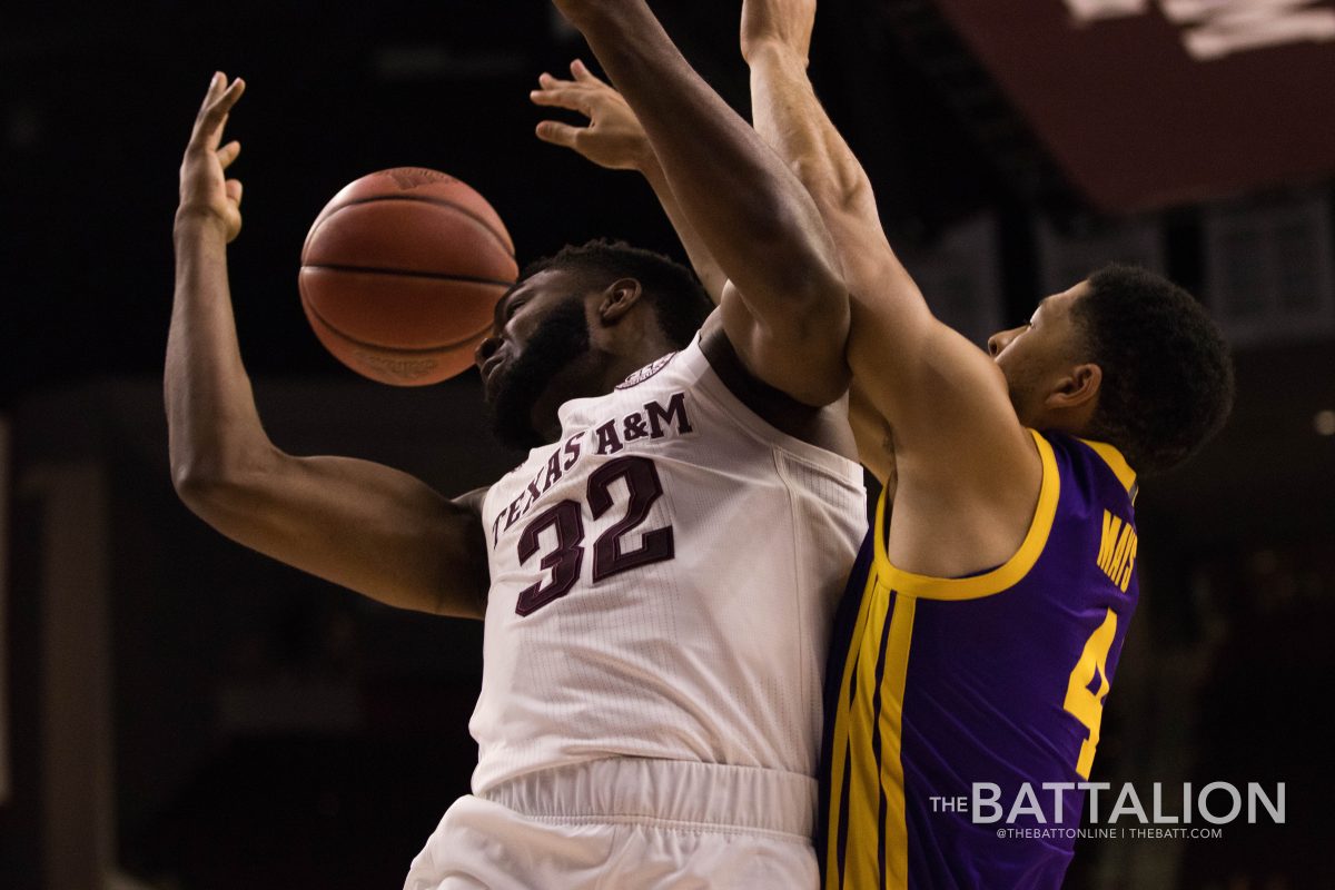 An LSU player knocking the basketball out of Josh Nebo's hands. Nebo has six offensive rebounds throughout the game.&#160;