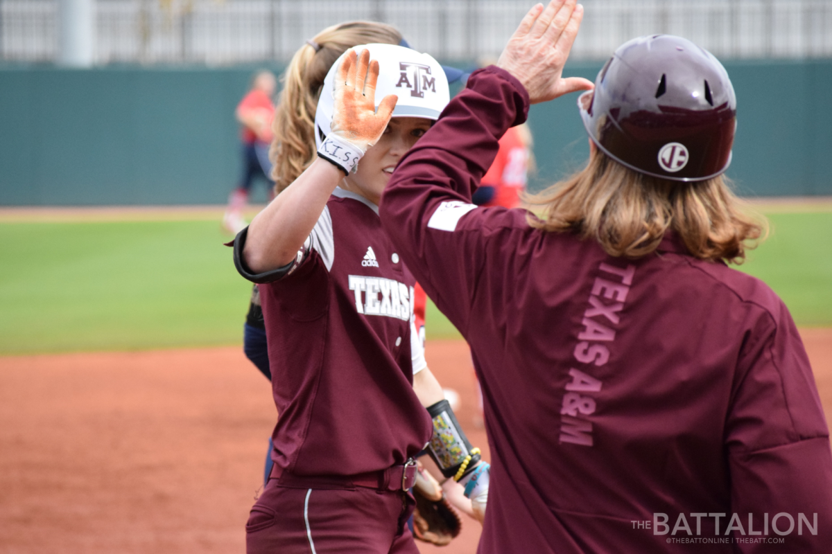 Senior Kelbi Fortenberry&#160;receives a high five after hitting a triple in the third inning.