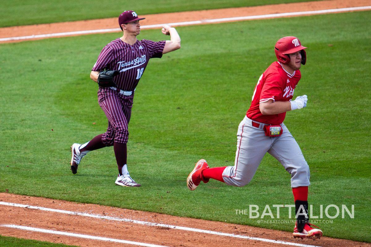 Chandler Jozwiak comes off the mound to field a ground ball and throw the runner out at first.