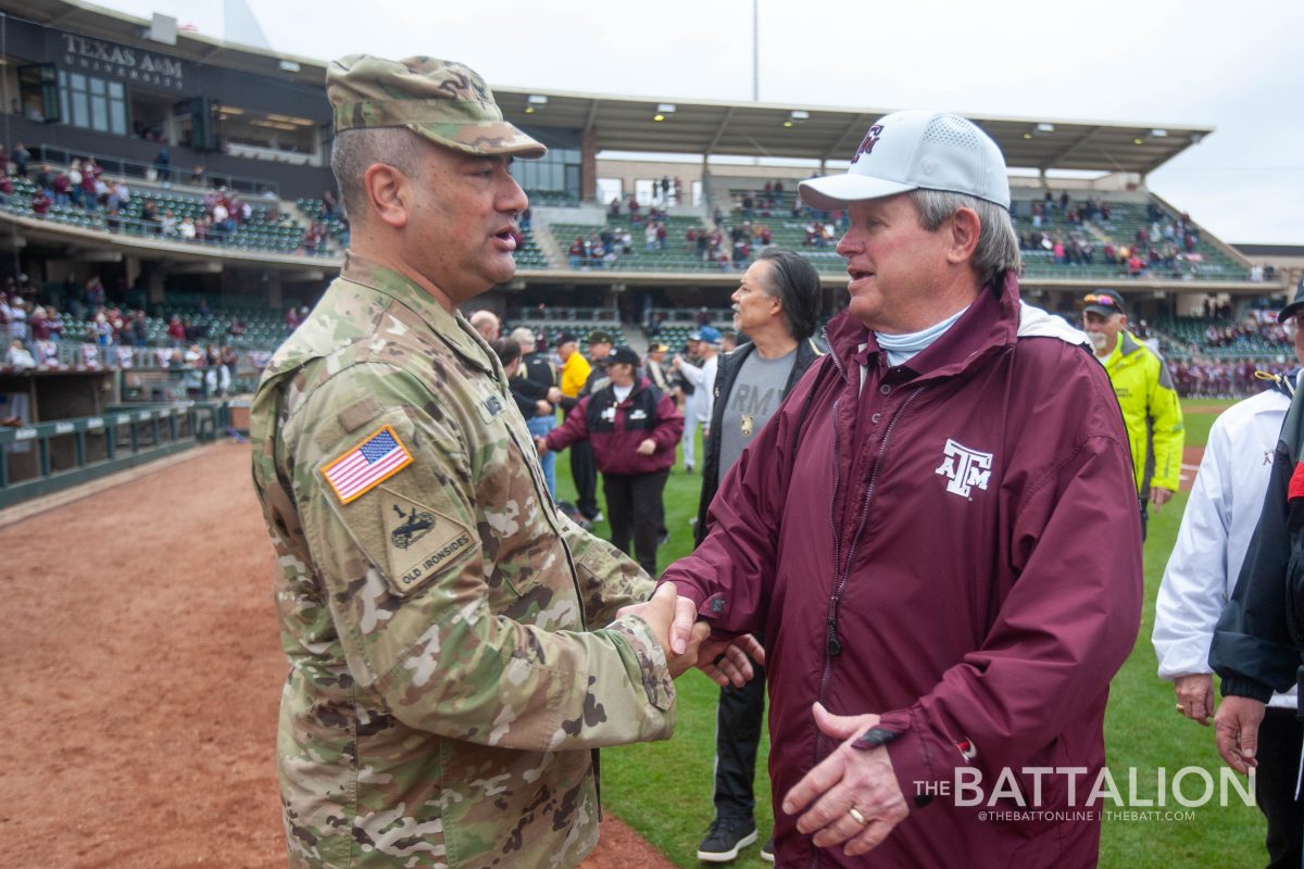 <p>West Point's Col. Rich Morales shakes hands with Aggie veterans after they are recognized for their service before the game.</p>