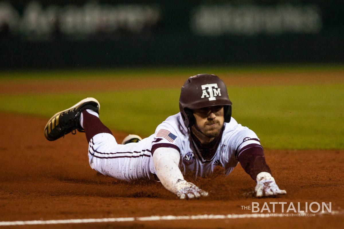 Center fielder Ray Alejo dives for third base.