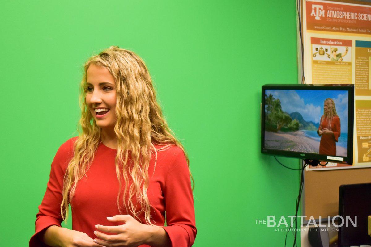 Meteorology junior Grace Leis practices for her broadcast in front of the green screen, which will air on KAMU-TV on Tuesday.