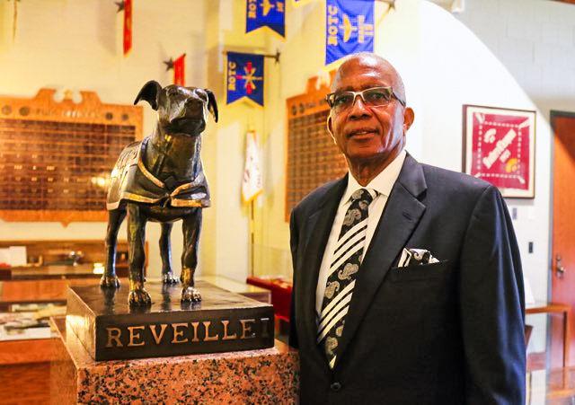 Eddie Chew Jr. stands with the statue of Reveille I in the Sanders Corps of Cadets Center. His parents Eddie Chew Sr. and Settie Mae were the original owners of “Puppy” or “Blackie” before she became Reveille I in 1931.