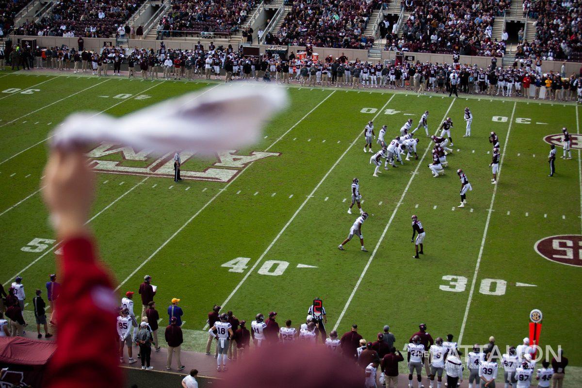 A student twirls their towel to cheer on the Aggie defense.