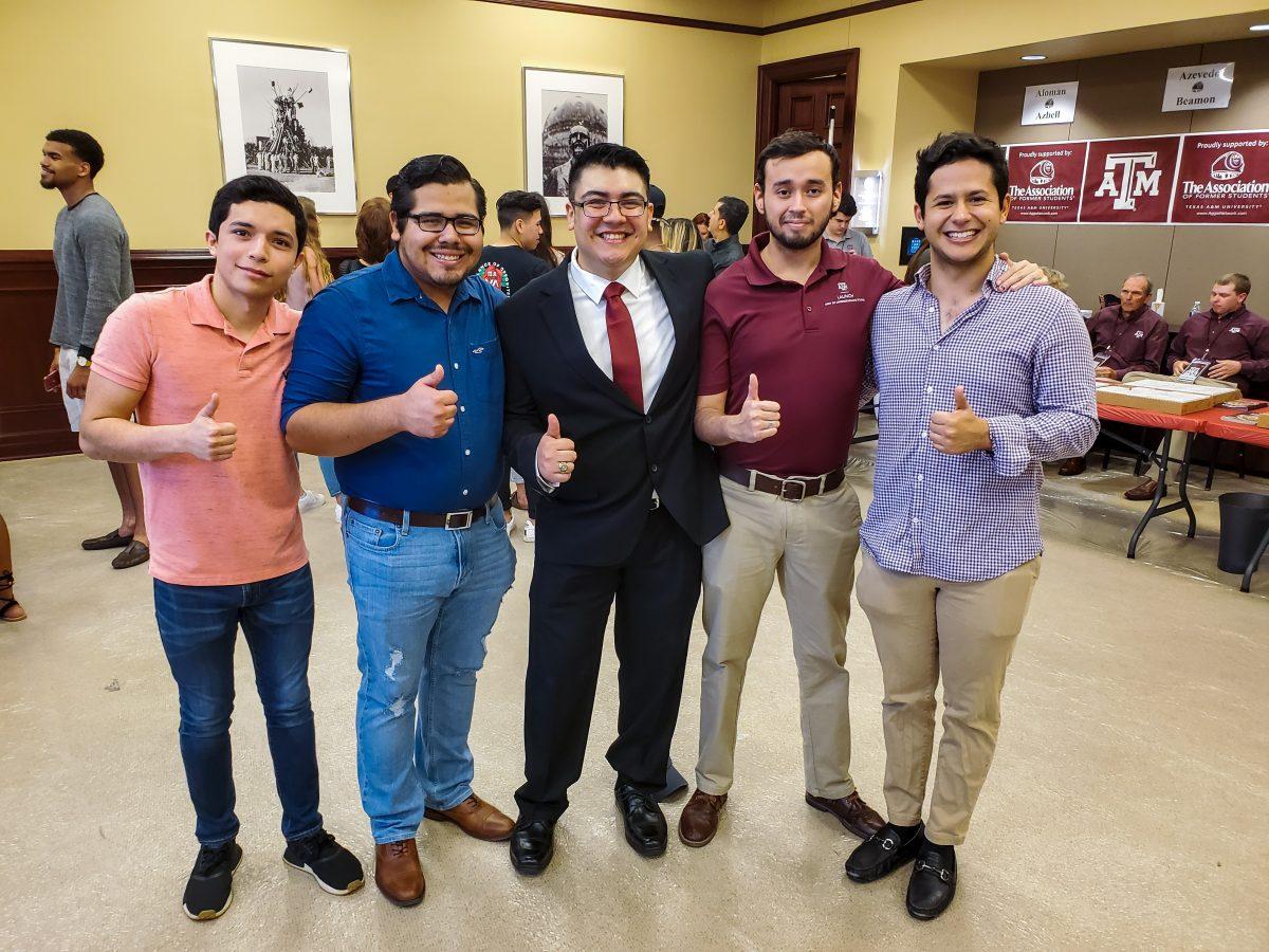 Multimedia editor Robert Castro (center) thanks the friends he made in Aggieland for the many memories hes made along the way.