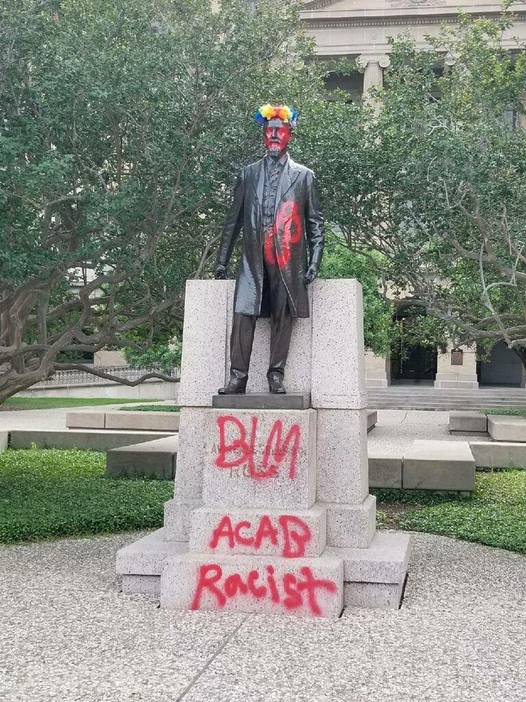 The+statue+of+Lawrence+Sullivan+Ross+was+defaced+overnight+with+graffiti.+By+mid-morning+the+statue+was+covered+by+employees+with+a+tarp.