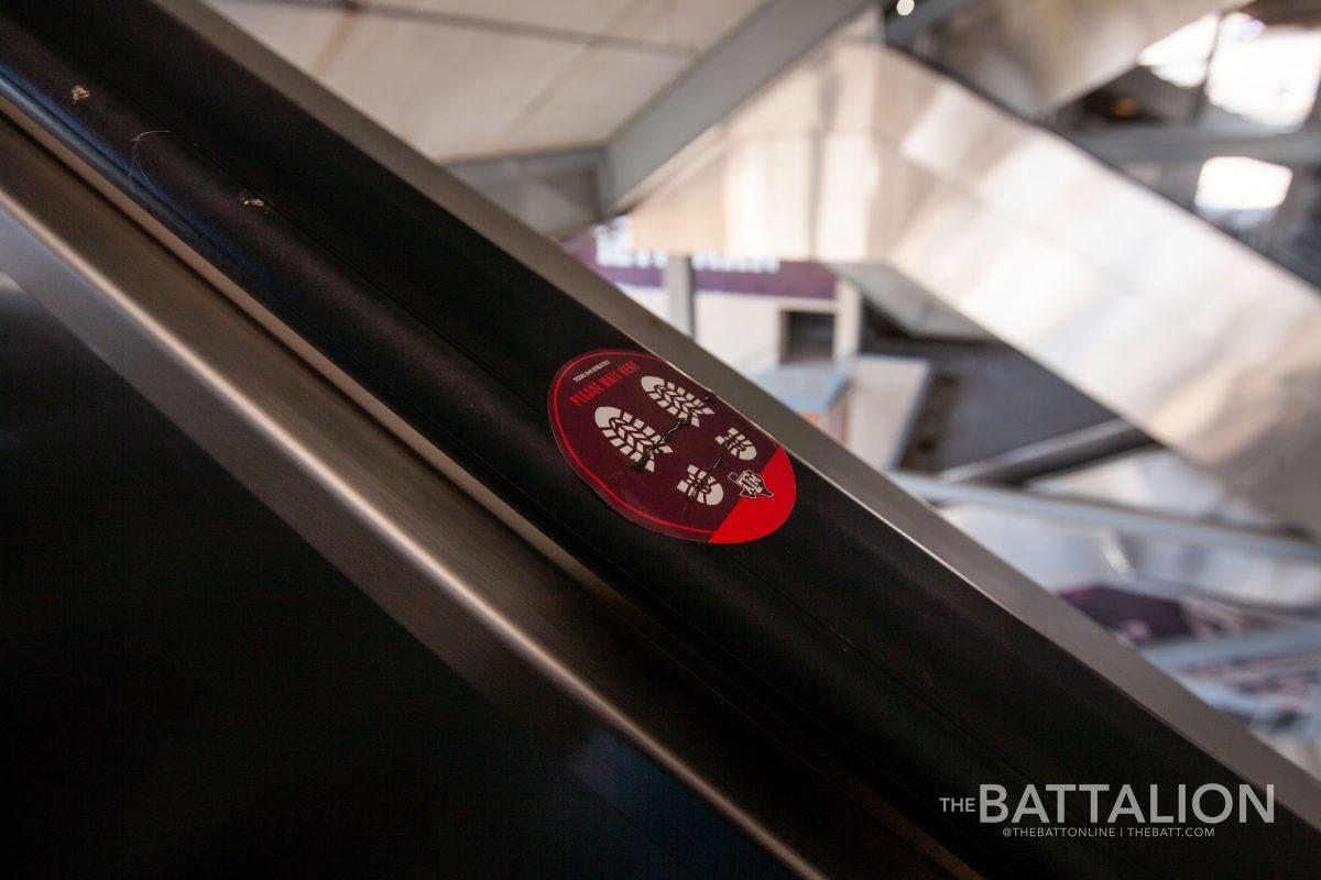 In addition to stickers on the ground to maintain social distancing there are also stickers located on handrails of escalators to assist in keeping six-feet apart.