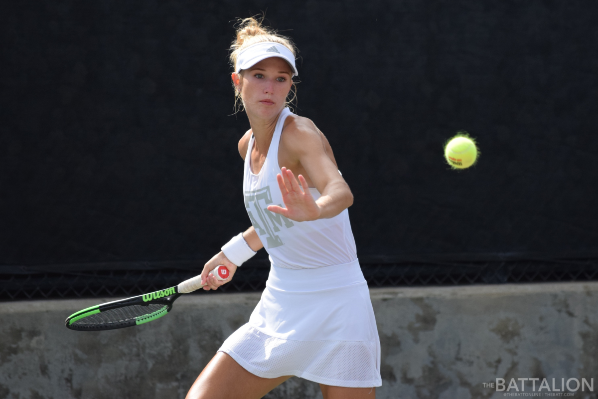 Freshman Elise Robbins returns a serve.