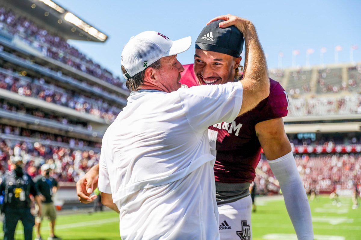 Texas A&M coach Jimbo Fisher and senior quarterback Kellen Mond celebrate after the 41-38 victory over the Florida Gators.