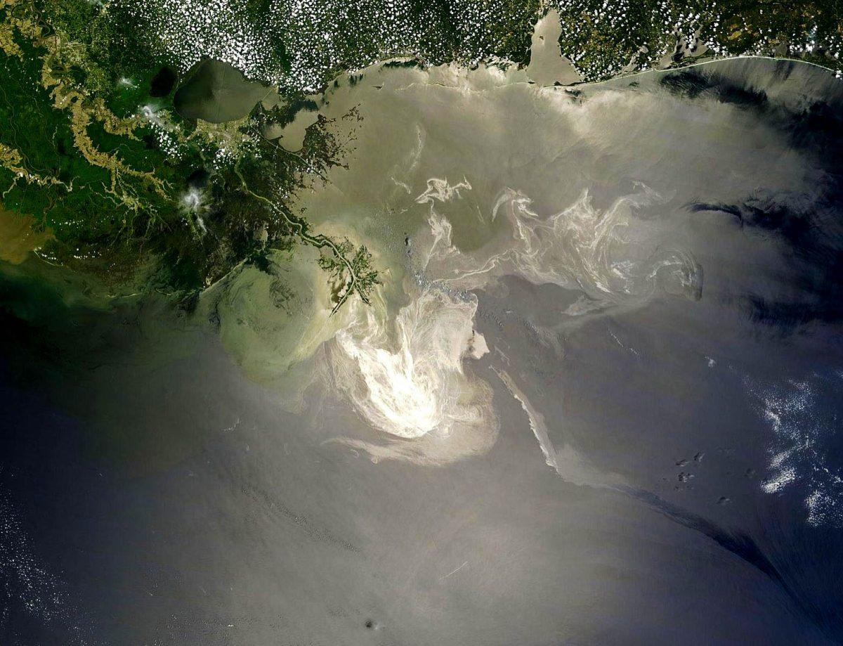 The once leftover oil from the Deepwater Horizon spill in the Gulf of Mexico swirls in iridescent eddies as it chokes the local ecosystem.