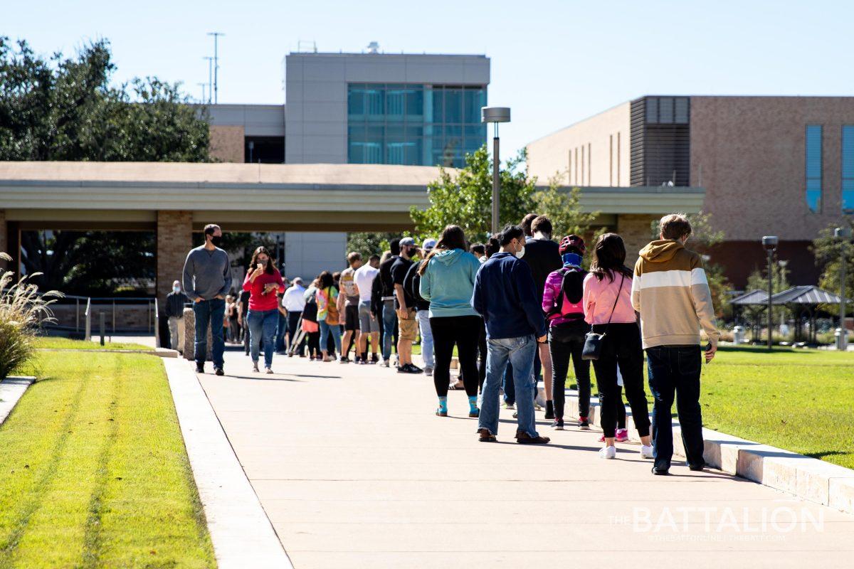 Voters wait to cast their ballot in a line on the north side of the Memorial Student Center on Texas A&amp;M's campus.