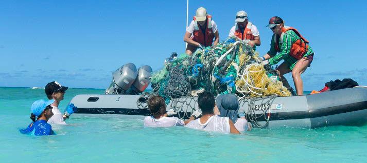 Volunteers in Hawaii collect marine litter. Debris in the water is a major factor impacting the health of ecosystems on the Texas coast.