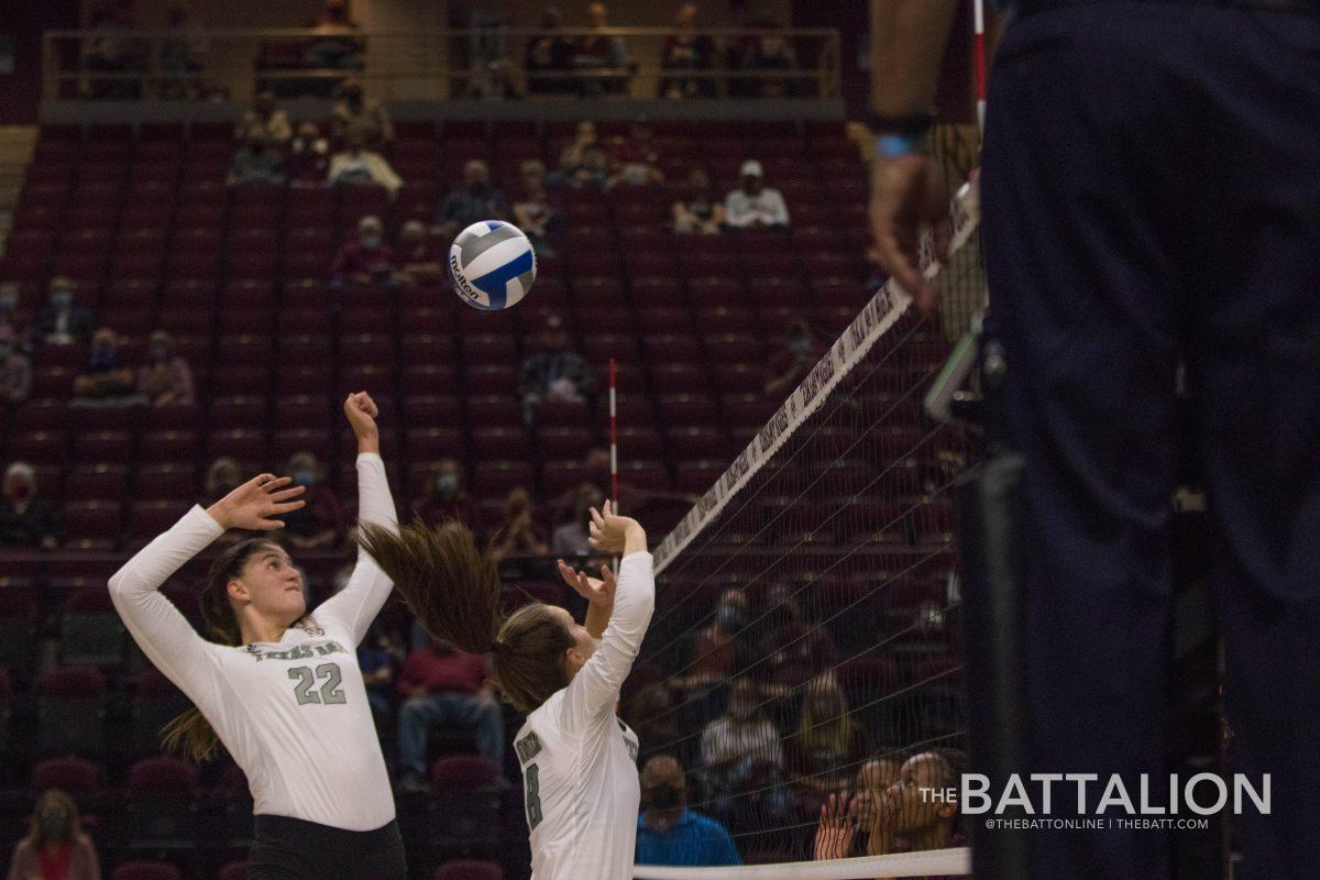 Senior opposite hitter Morgan Davis and senior setter Camille Conner work together to put the ball over the net. 