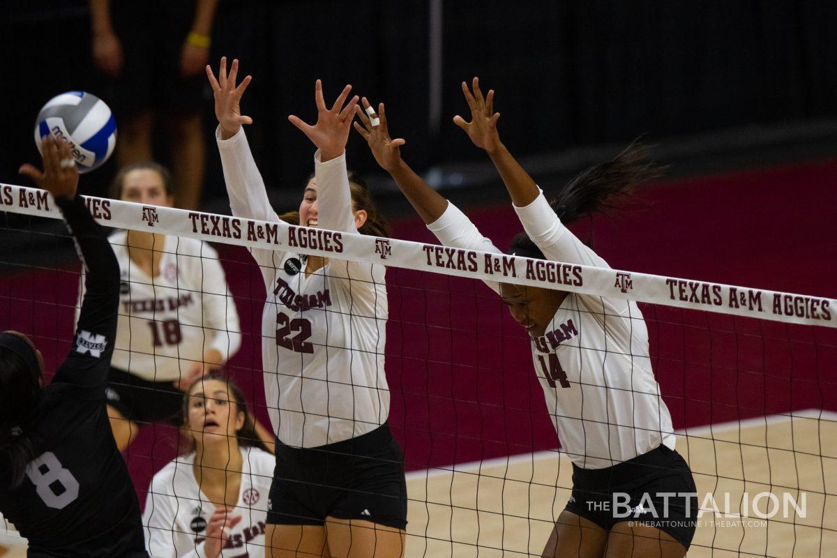 Opposite hitters Morgan Davis and Treyaunna Rush go up for a block.