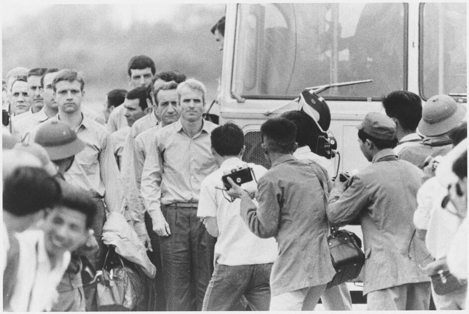 John McCain waiting for the rest of the group to leave the bus at the airport after being released as a Prisoner of War.