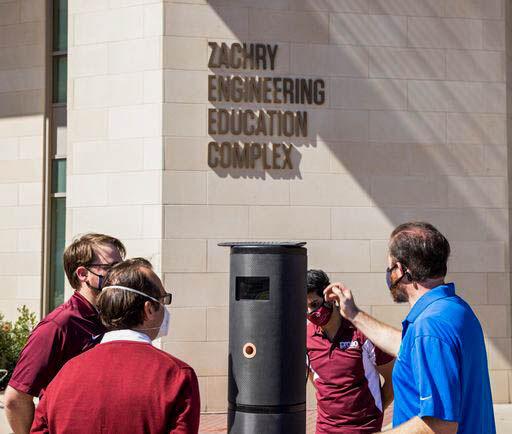 Aggies blow into disposable straws to test new Worlds Protect kiosk stationed at the Zachary Engineering Education Complex.