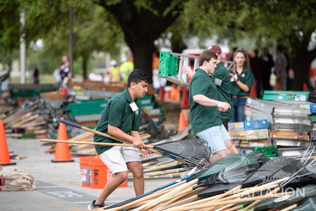 Big Event volunteers rush to distribute tools to each group at the 2019 Big Event.