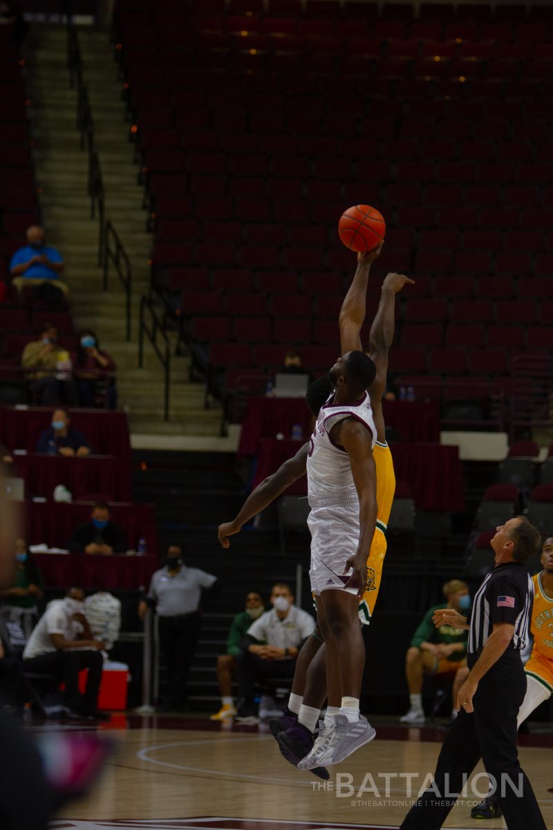 Sophomore forward Jonathan Aku goes up for the tipoff.