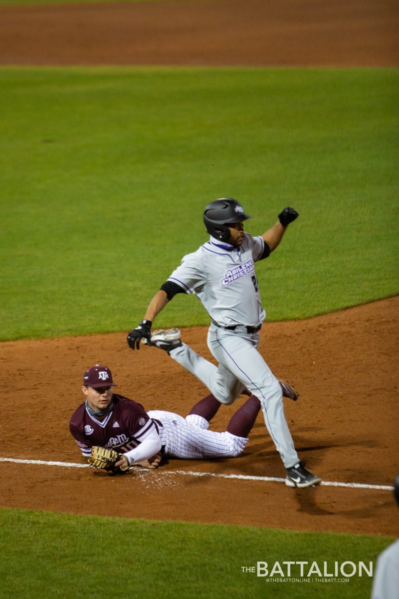 Abilene's outfielder and graduate student Mike Brown leaps over Hunter Coleman to reach first base.