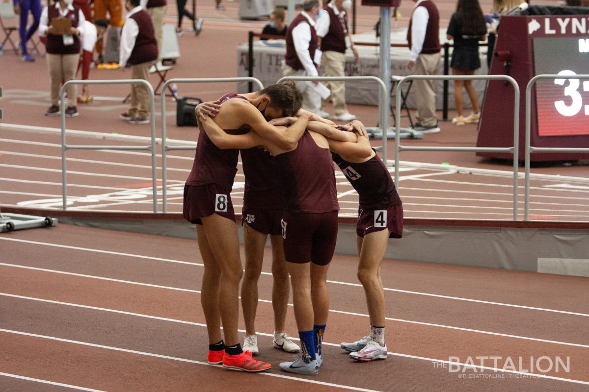 The Aggie mens milers talk tactics before starting the race.