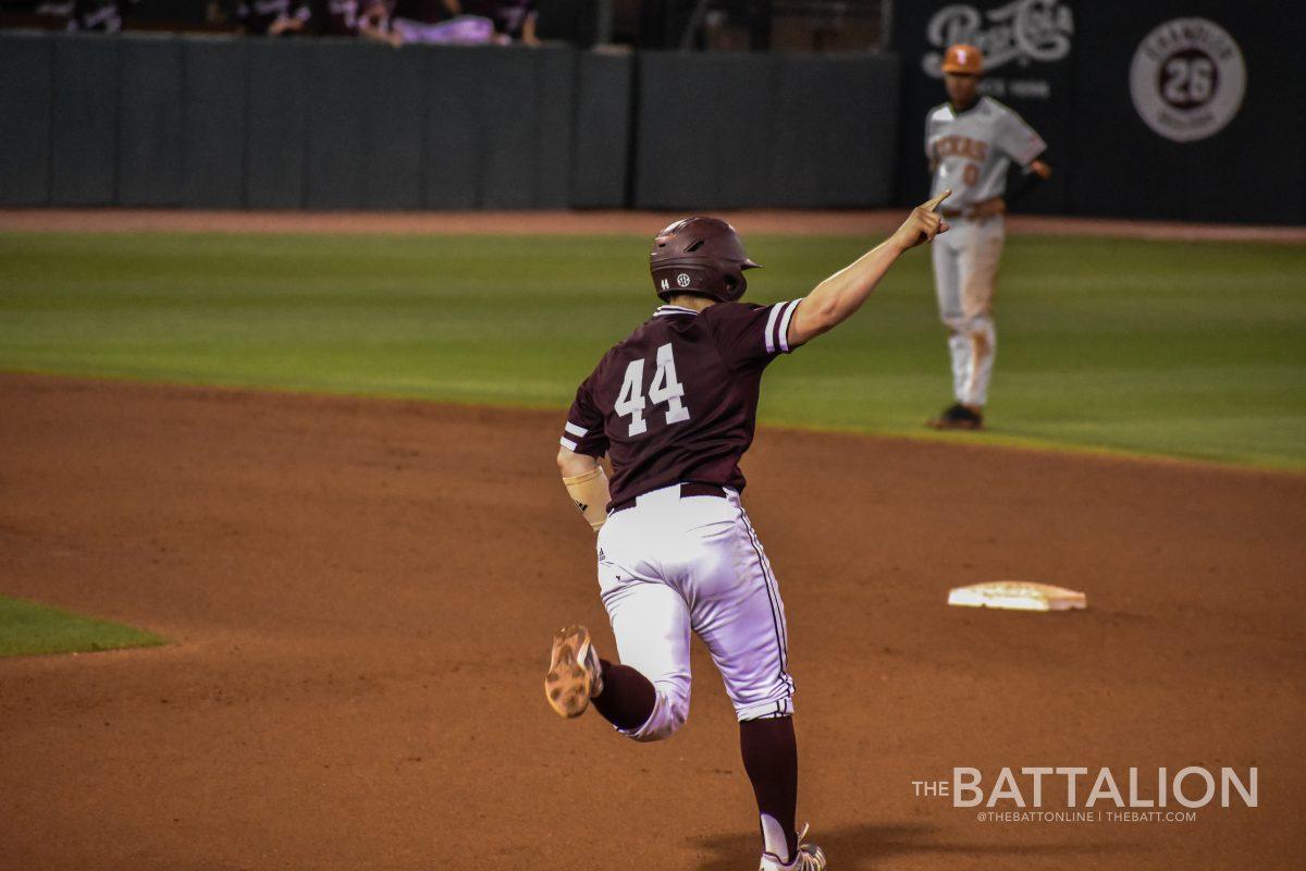Mikey Hoehner celebrates his home run while he runs the bases of Olsen Field. 