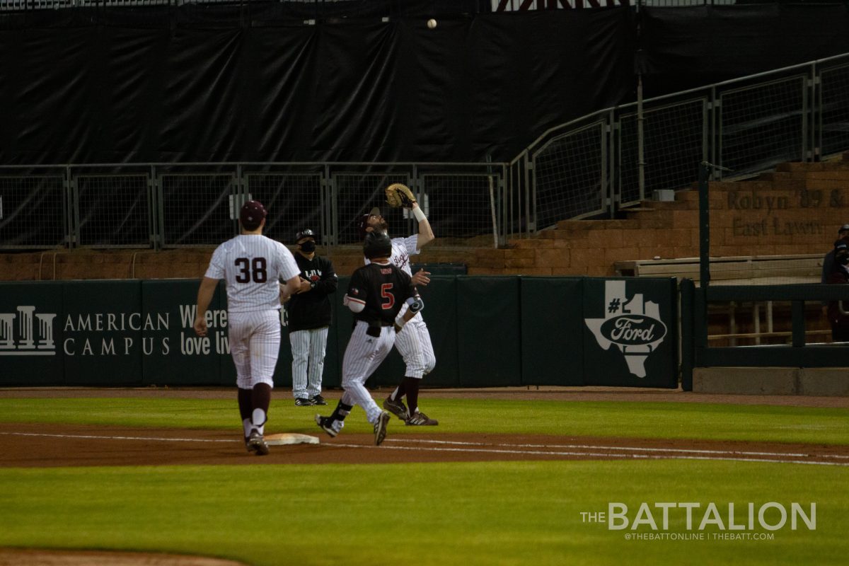 Junior Will Frizzell catches a pop fly to get the batter out.