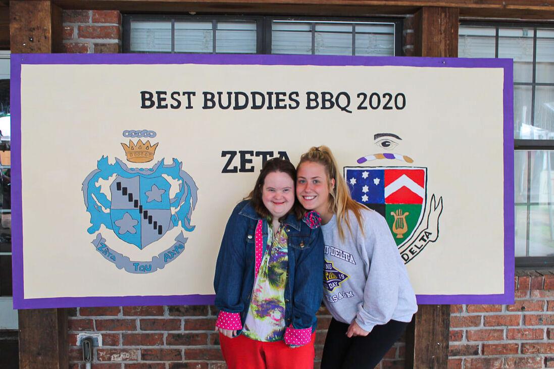 Ashley Odom smiles with her buddy, Morgan, at the annual barbecue with Delta Tau Delta.