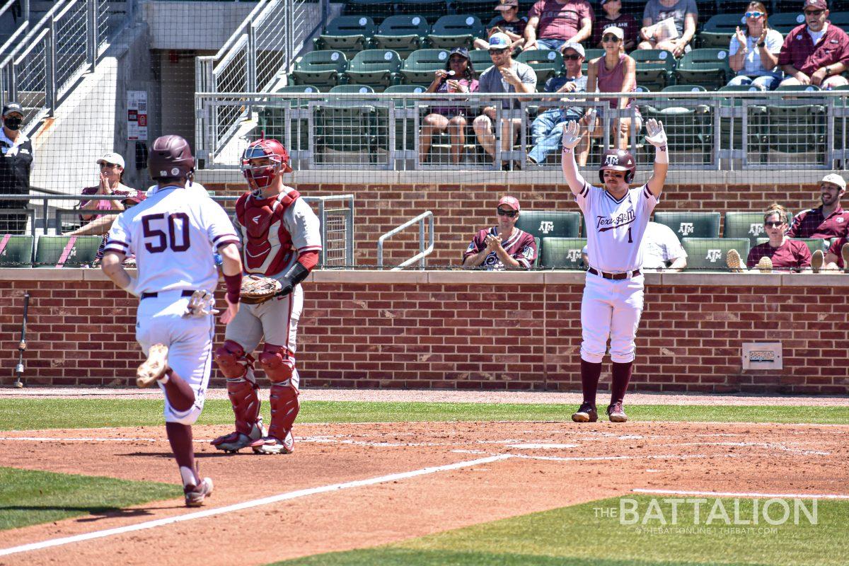 Junior infielder Ty Coleman cheers for teammate Will Frizzell as he approaches home plate in a game against Alabama. 