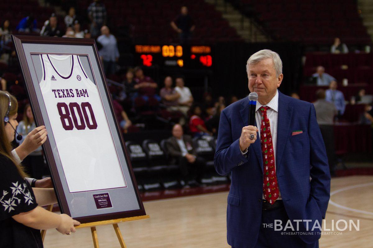 Coach+Blair+receiving+an+honorary+jersey+after+leading+the+Aggie+Womens+Basketball+team+to+their+800th+win+on+Dec.+15%2C+2019.