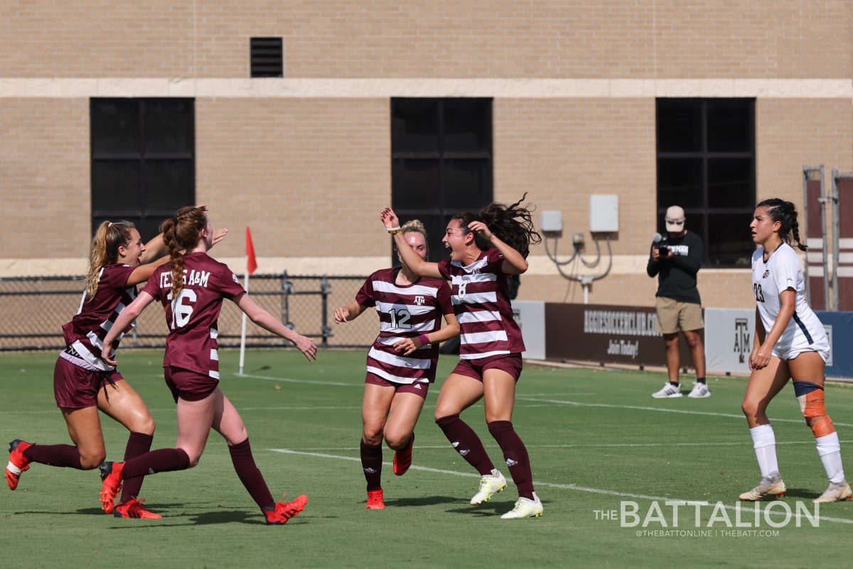 The Aggies celebrate after scoring a goal.