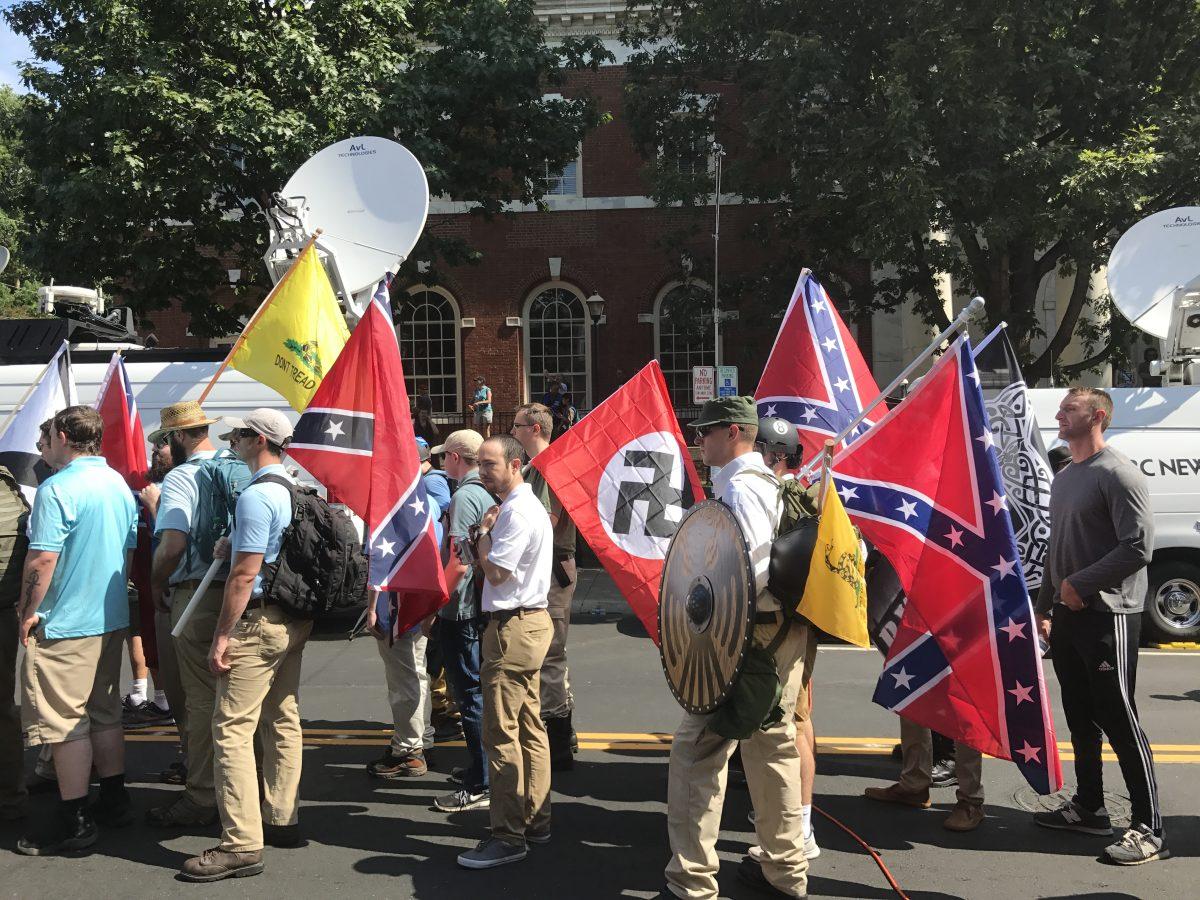 Alt-right members preparing to enter Emancipation Park holding Nazi, Confederate Battle, Gadsden Dont Tread on Me, League of the South, and Thors Hammer flags. Photo by Anthony Crider via Creative Commons