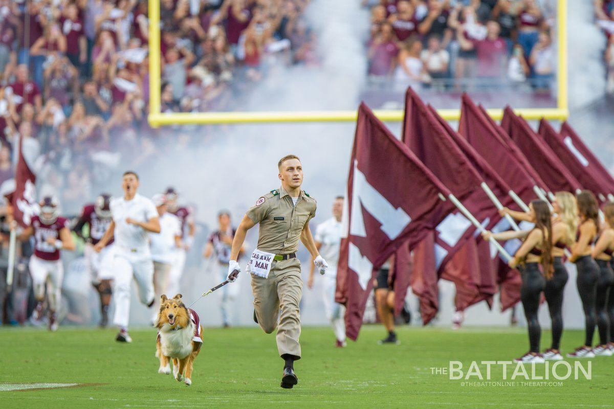 Reveille+and+her+handler+sophomore+Lucas+Scroggins+run+out+on+to+Kyle+Field.