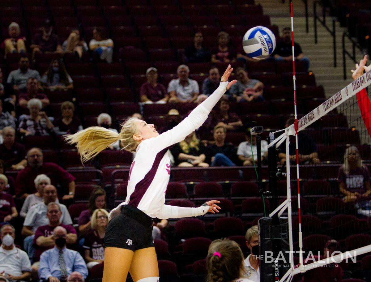 Junior Cici Hecht hits the ball her teammate set for her.