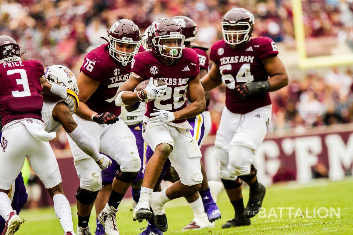 Junior Isaiah Spiller&#160;carries the ball towards the endzone.