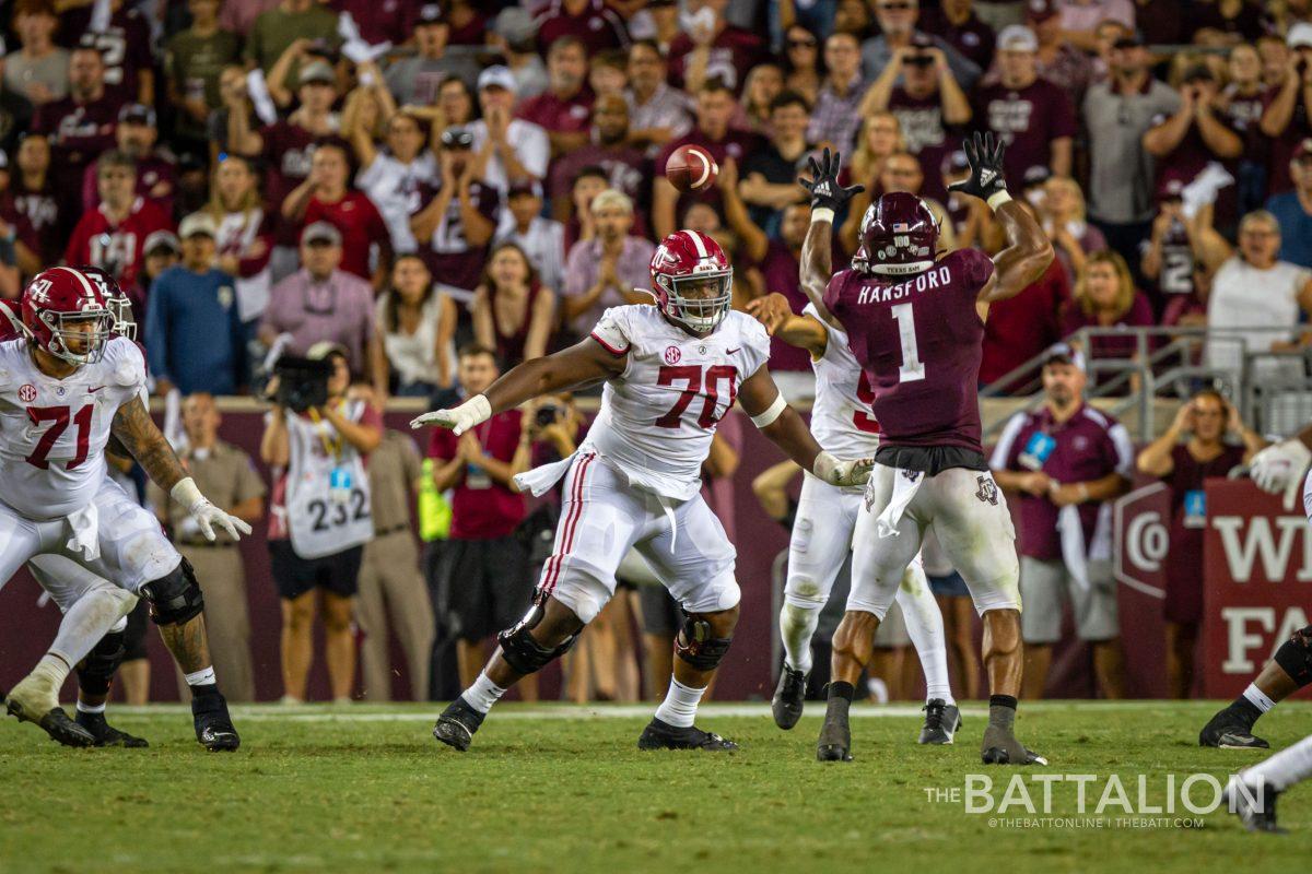 Graduate student linebacker Aaron Hansford attempts to block a pass thrown by Alabama quarterback Bryce Young.