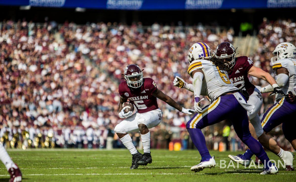 Sophomore Devon Achane navigates which path he should take down the field.