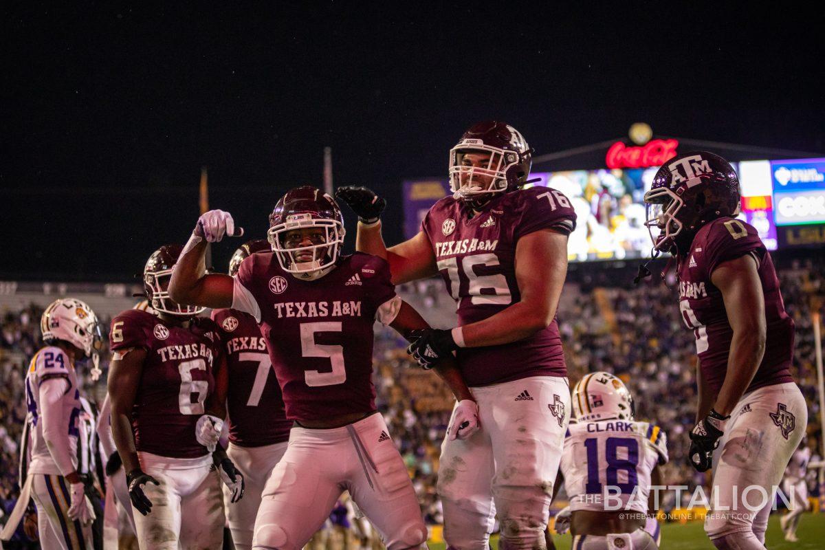 Junior wide receiver Jalen Preston (5) celebrates in the end zone with freshman offensive lineman Reuben Fathree II (76) and junior wide receiver  Ainias Smith (0) in the fourth quarter of the game against LSU on Saturday, Nov. 27.