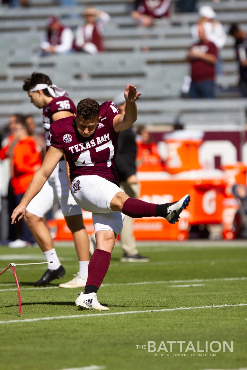 Before the game, senior placekicker&#160;Seth Small practices with his teammates.