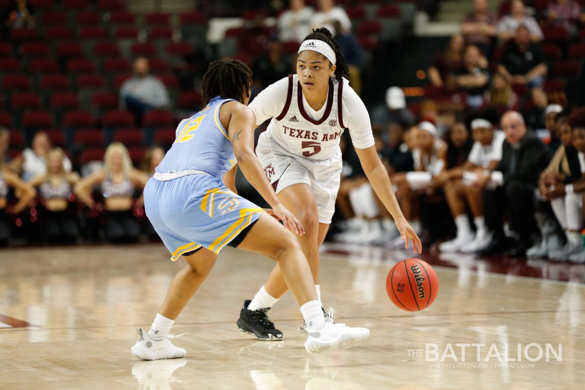 Junior guard, Jordan Nixon dribbles an opponent during the game.