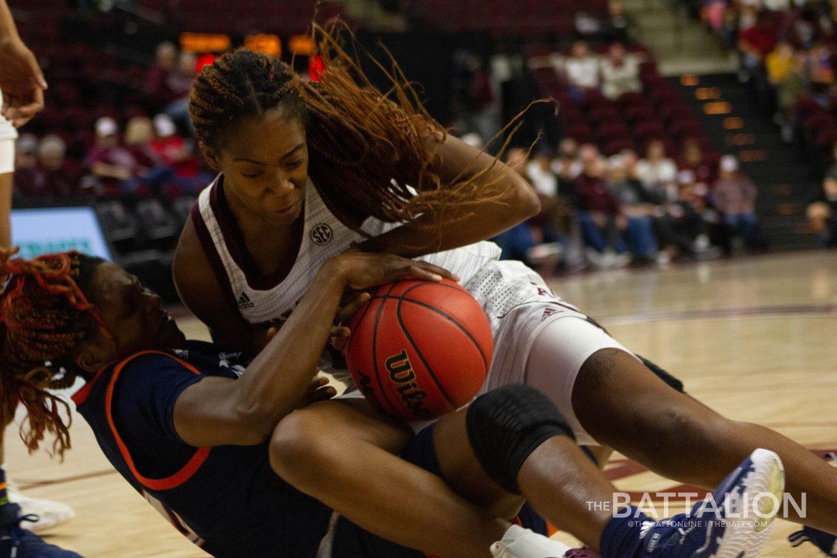 Aggie senior forward Aaliyah Patty and UTSA junior guard Queen Ulabo fight for the ball.