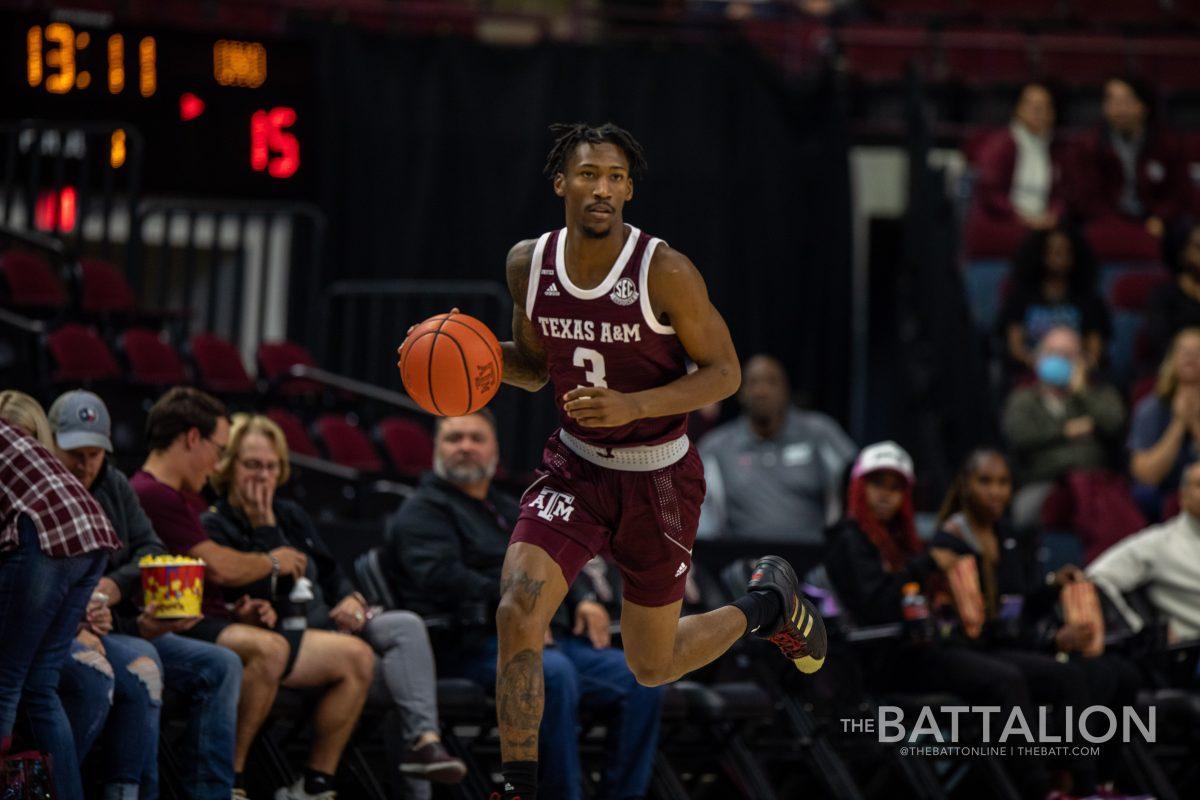 Fifth year guard Quenton Jackson (3) runs down the court in Reed Arena on Nov. 30, 2021.