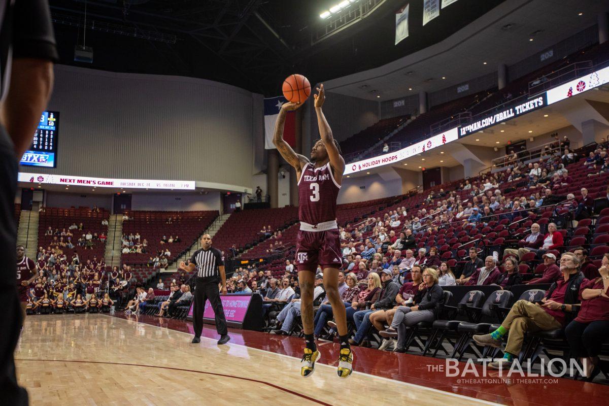 Fifth year guard Quenton Jackson (3) shoots a three-pointer late in the second half in Reed Arena on Nov. 30, 2021.