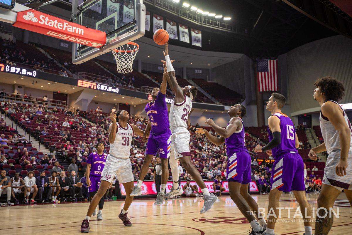 Junior guard Tyrece Radford (23) jumps to score on the Demons in Reed Arena on Tuesday, Dec. 21, 2021.