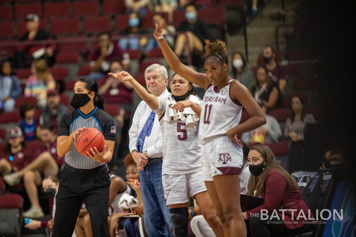 Redshirt junior guard Jordan Nixon (5) and graduate guard Kayla Wells (11) coach their teammates during their time on the bench in the Aggies game against the Gators in Reed Arena on Sunday, Jan. 9, 2022.