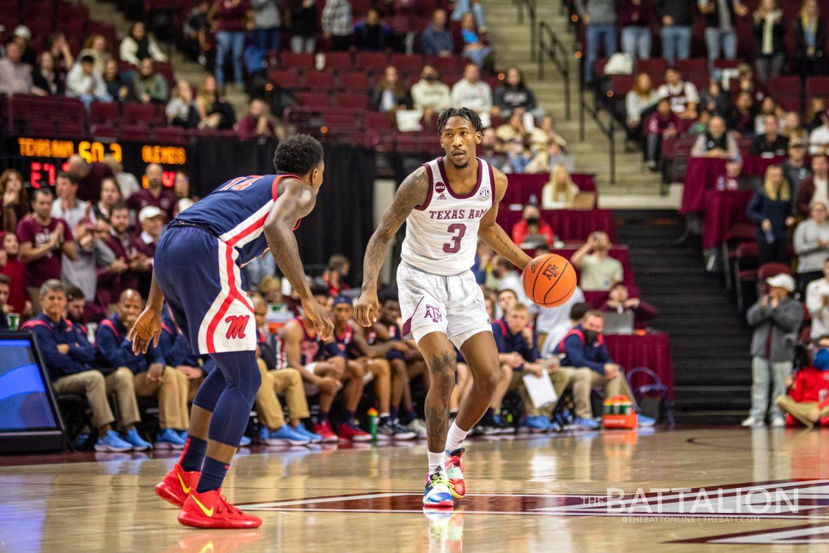 Fifth year guard Quenton Jackson (3) runs out the clock during the final minute of the Aggies game against the Rebels in Reed Arena on Tuesday, Jan. 11, 2022.